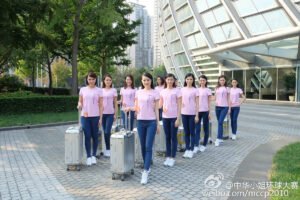 Girls walking down with suitcase