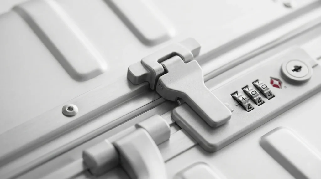 Zipperless luggage frame closure detail — latch and TSA lock security mechanism replacing fabric zipper