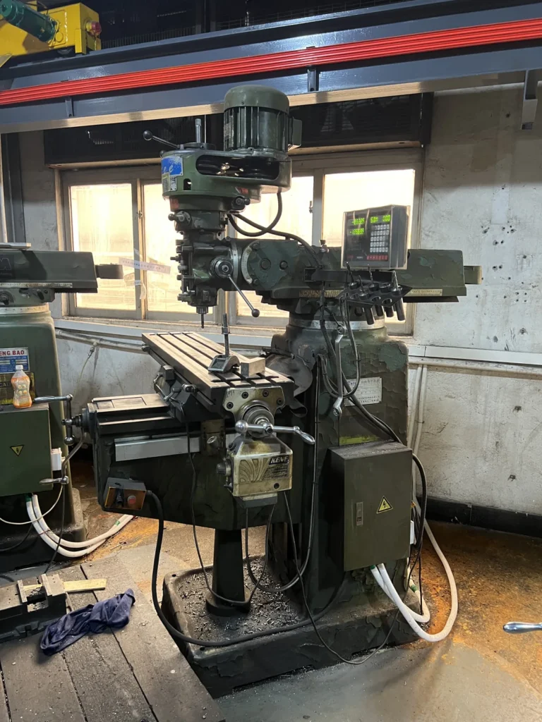 Milling and engraving station where marks are cut into aluminum case parts