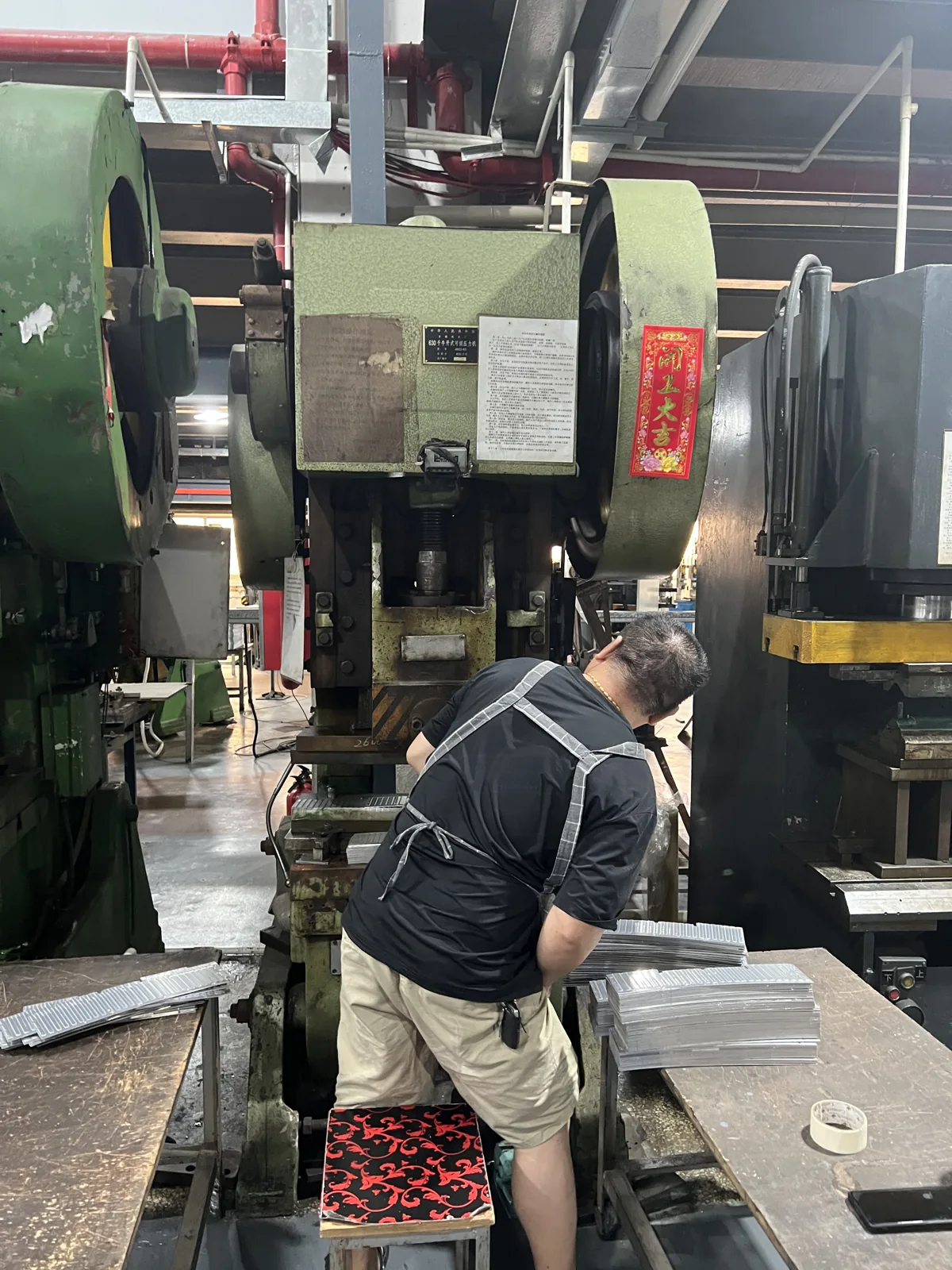 Operator working a press station in the metal forming shop