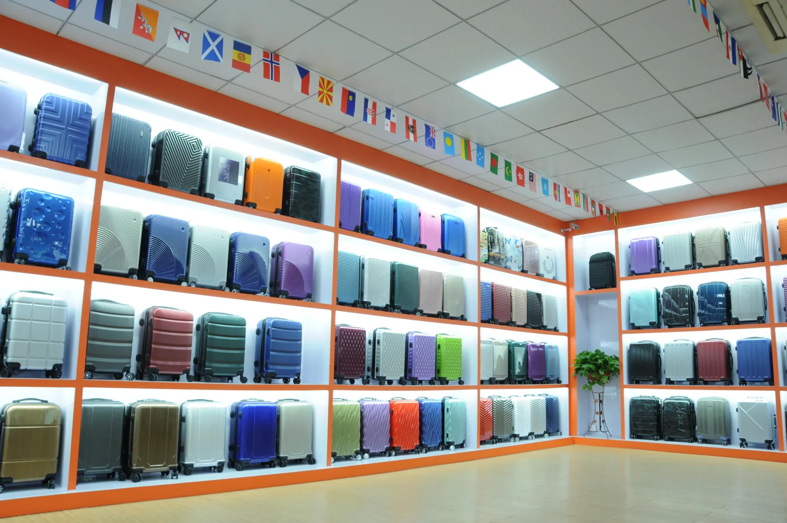 Showroom shelves filled with hard shell suitcases in many different colors and surface finishes