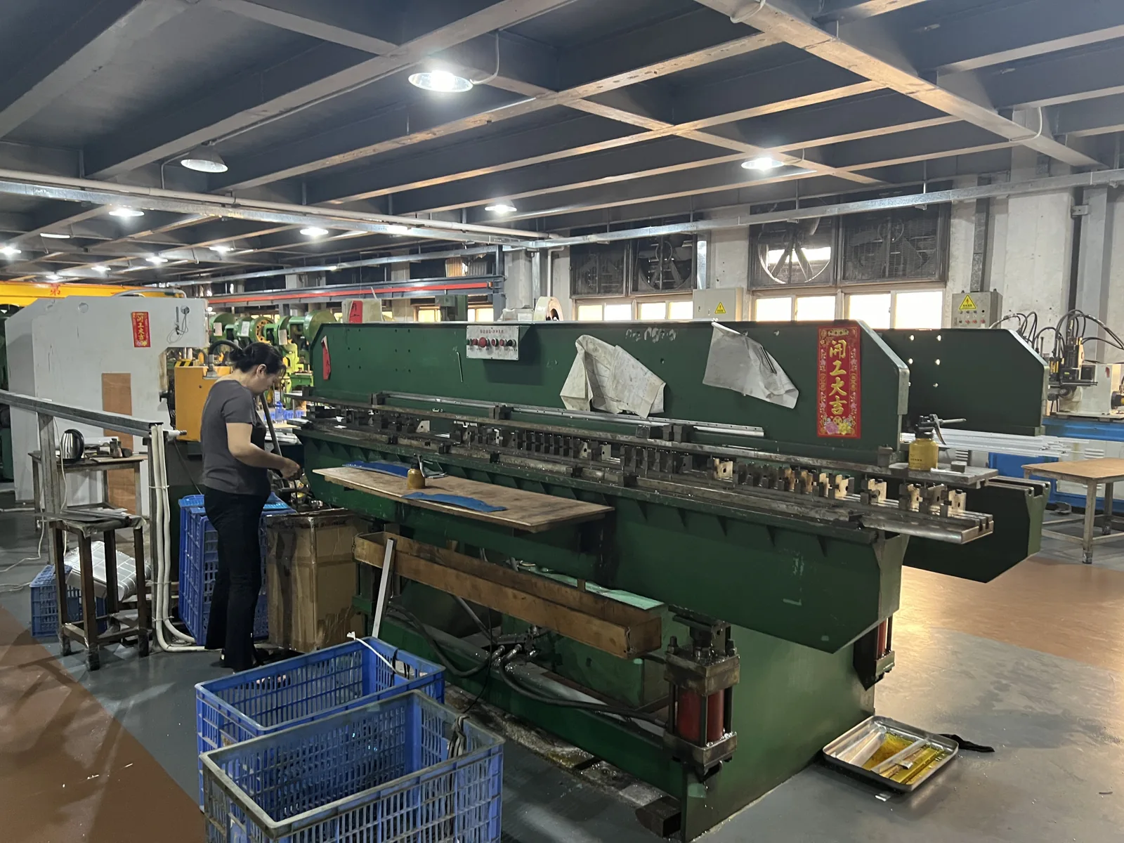 Shearing and bending station where aluminum sheet is cut to size for case shells