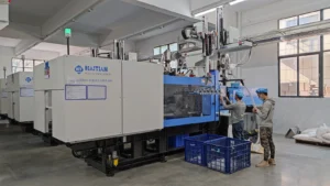 Row of Haitian injection molding machines with robot take-out arms running plastic luggage components