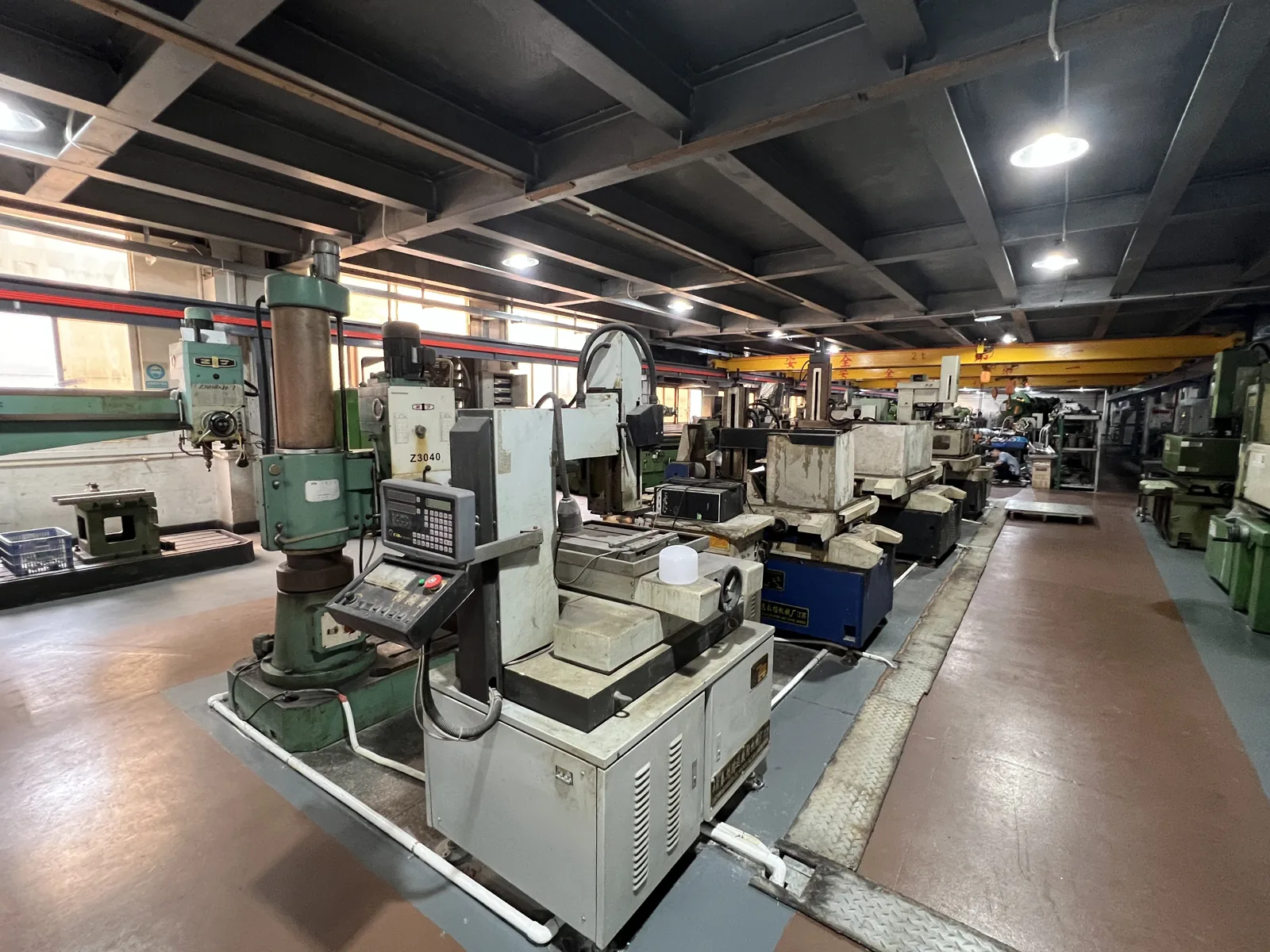 Tool room at the Aluvox luggage factory with a Z3040 radial drill and sinker electrical discharge machines used to cut punch die blocks