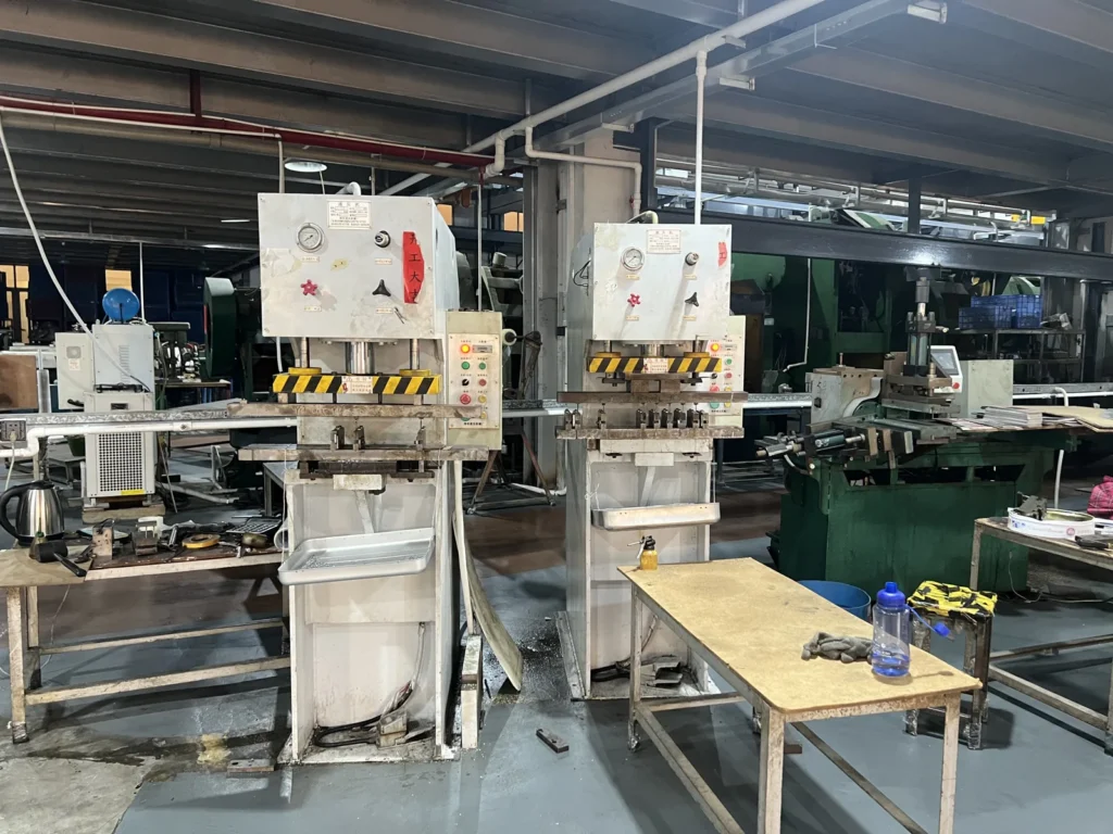 CNC machining center cutting a battery cavity into an aluminum luggage frame at the Aluvox factory in Dongguan