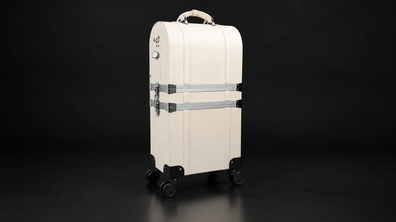 Cream two-tier makeup trolley case with aluminum straps from the Aluvox factory, studio shot on black