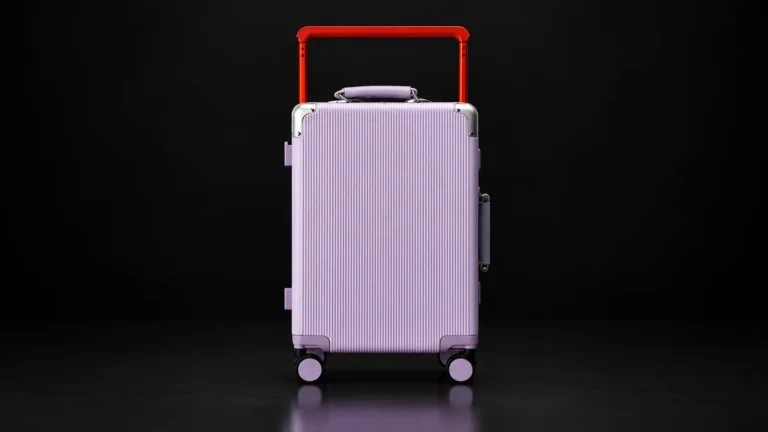 Lavender ribbed polycarbonate zipperless suitcase with red telescopic handle from the Aluvox range, studio shot on black