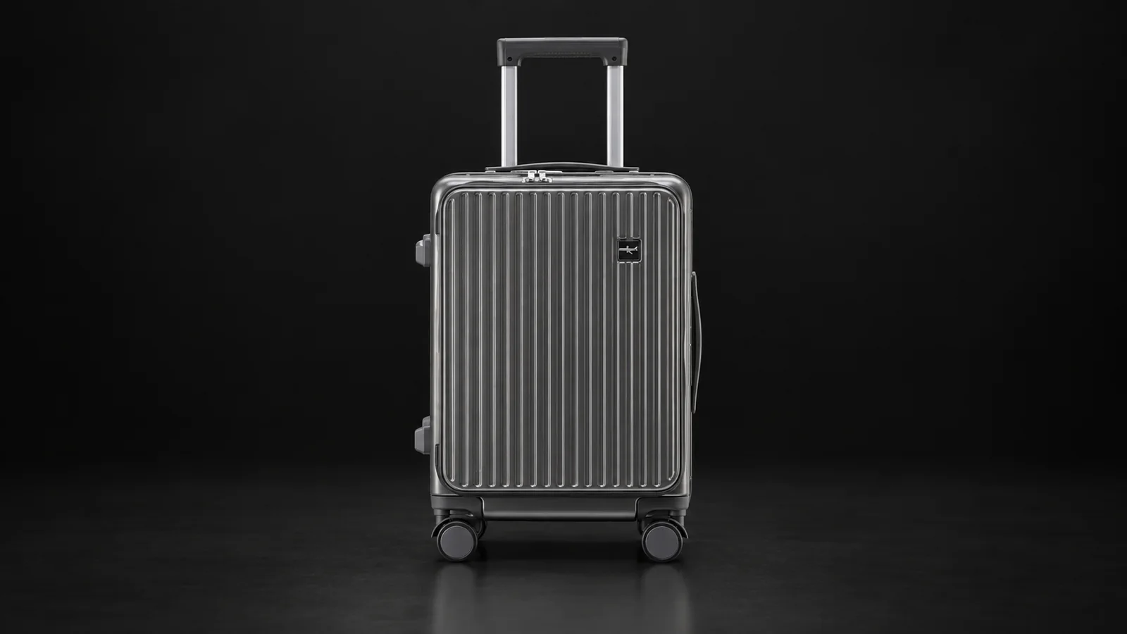 Grey ribbed front-opening suitcase from the Aluvox range, studio shot on black