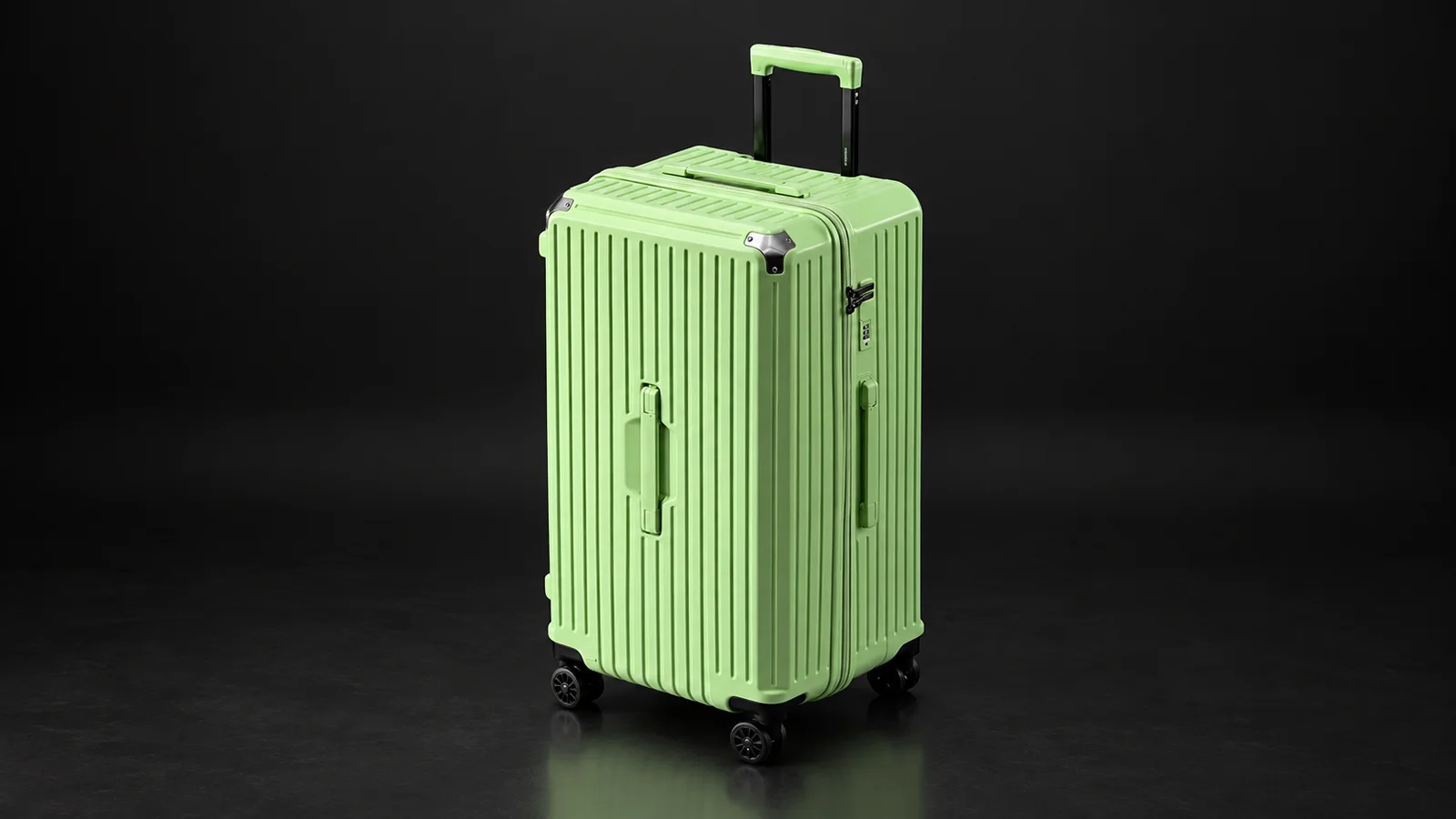 Green ribbed polycarbonate zipper suitcase from the Aluvox range, studio shot on black