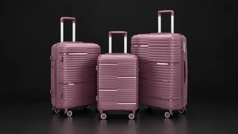 Three sizes of a purple polypropylene suitcase from the Aluvox range, studio shot on black