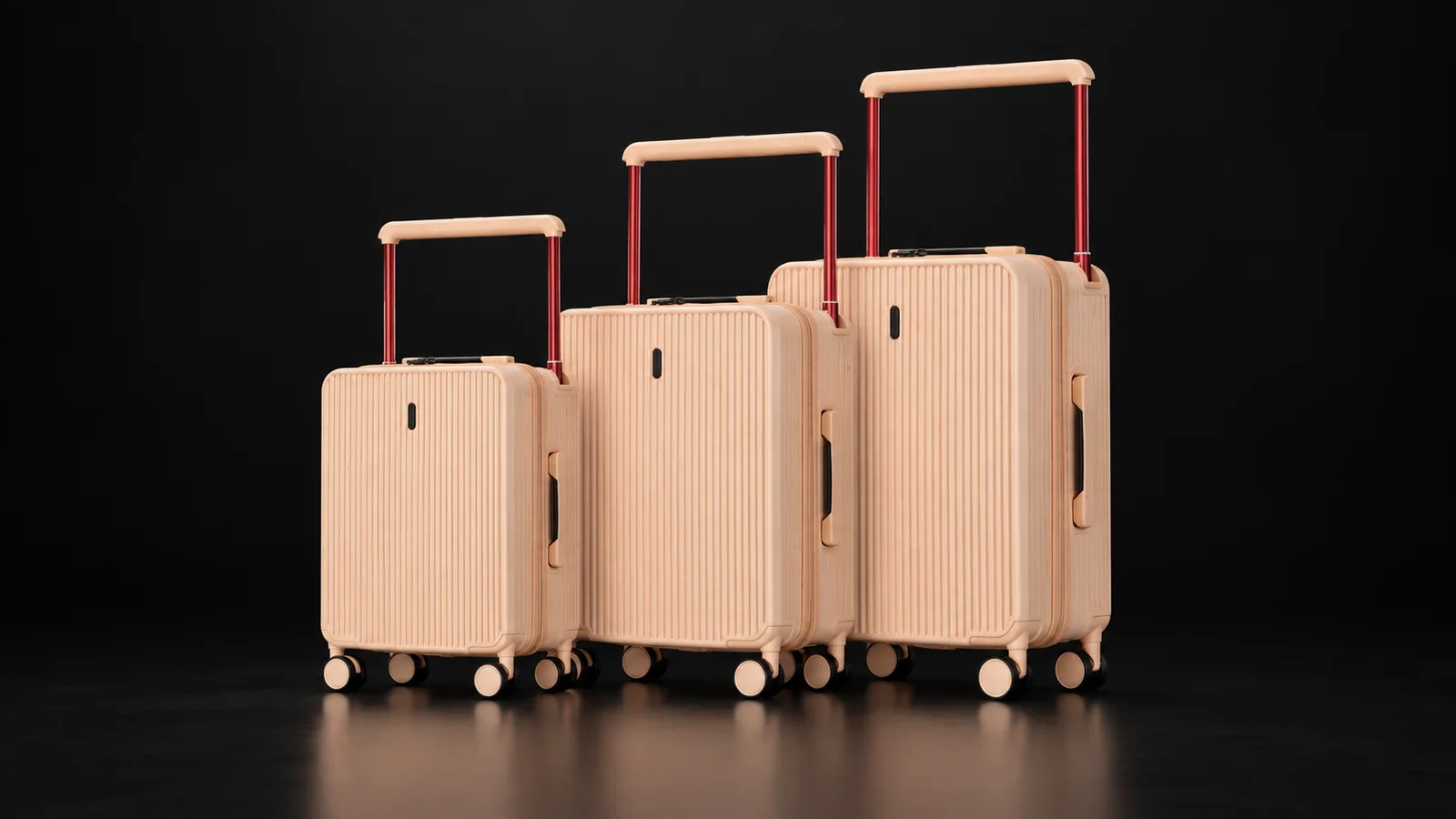 Three sizes of a beige aluminum-frame polycarbonate suitcase from the Aluvox range, studio shot on black