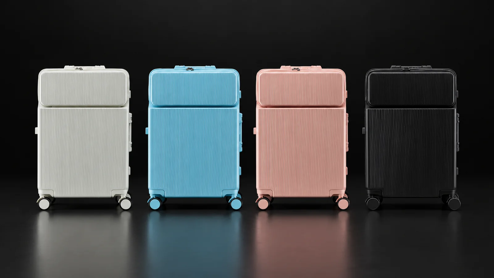 Four front-opening polycarbonate suitcases from the Aluvox range in white, blue, pink and black, studio shot on black