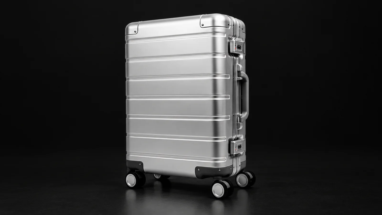 Silver ribbed aluminum suitcase from the Aluvox factory, three-quarter view, studio shot on black